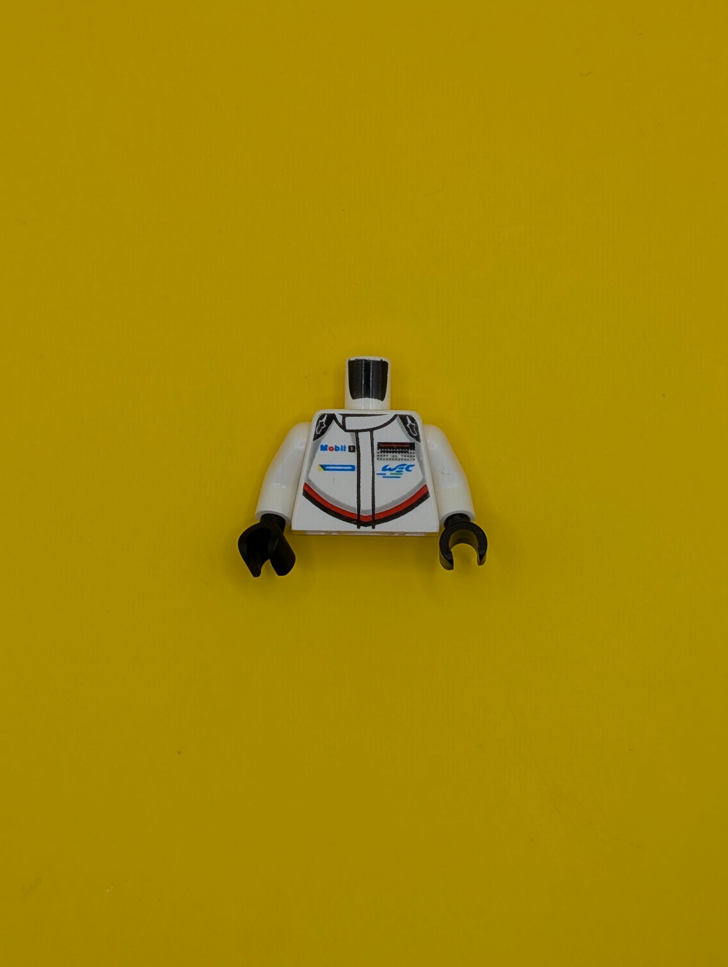 973pb3322c01 Torso Speed Champions with Mobil 1 and WEC Logo on Front, Porsche Design Logo on Back Pattern / White Arms / Black Hands Lego Part