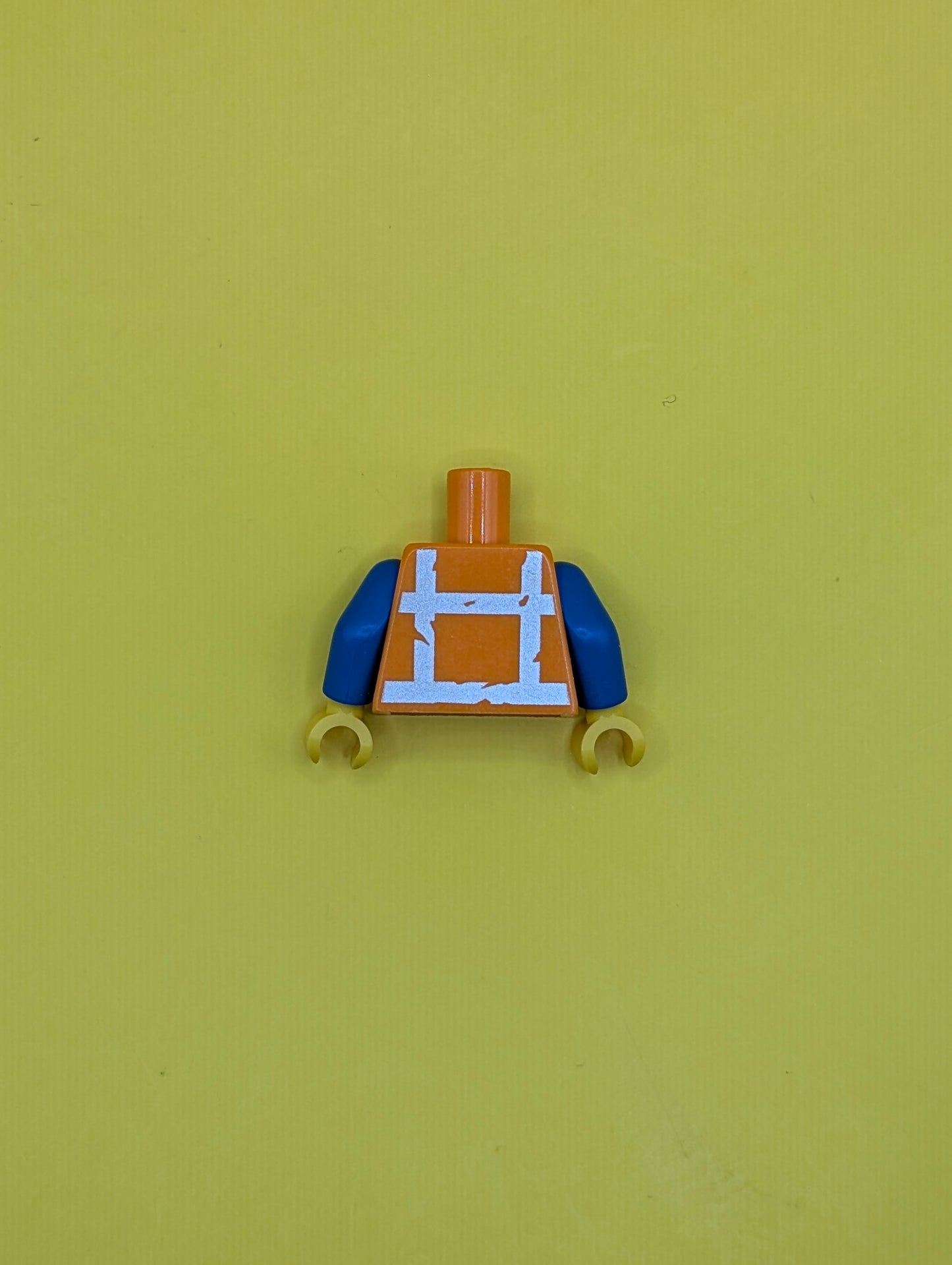 973pb3370c01 Torso Safety Vest with Reflective Worn Crossed Stripes over Blue Shirt Pattern / Blue Arms / Yellow Hands Lego Part