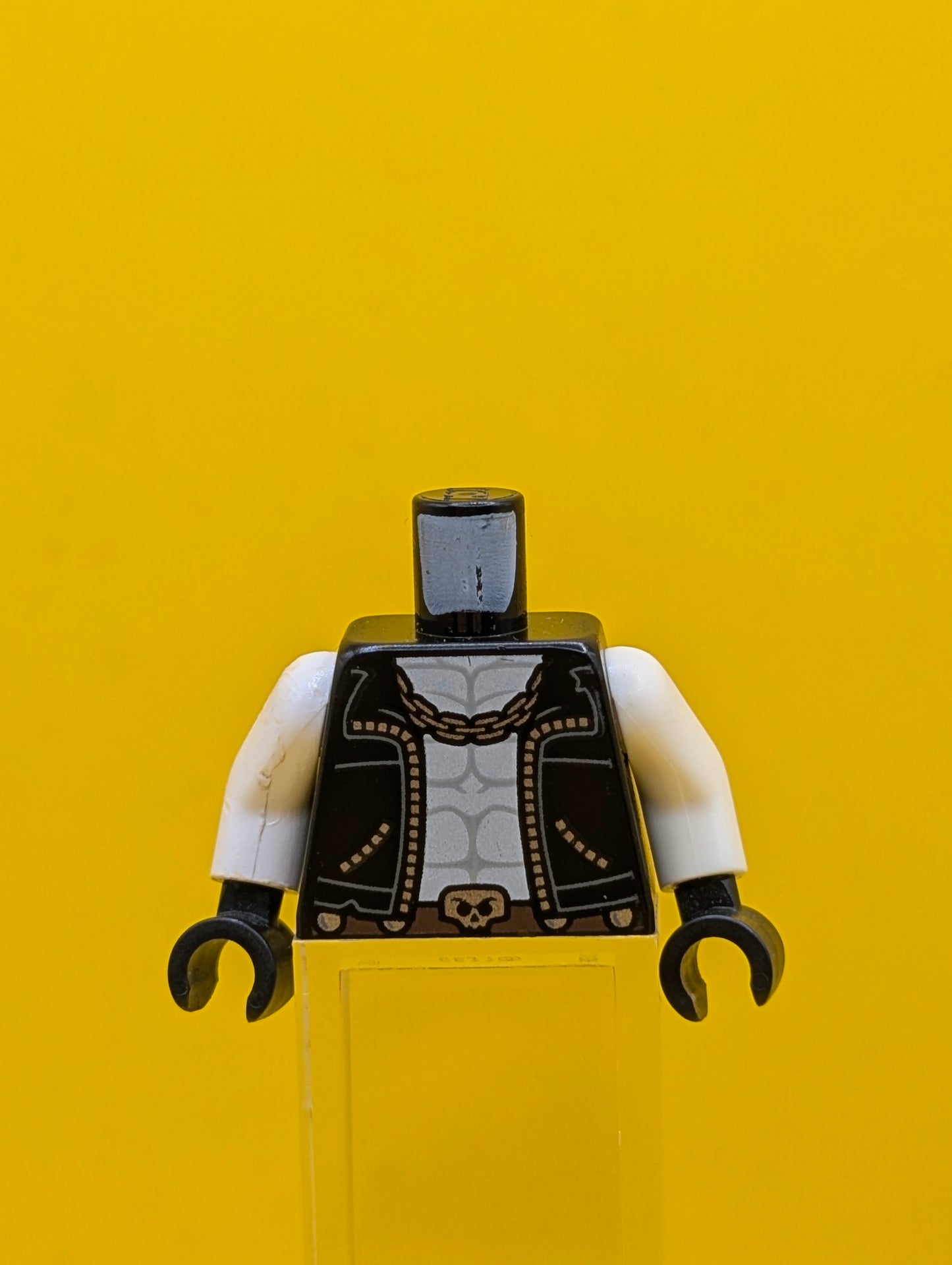 973pb2994c01 Torso Biker Vest, White Chest with Muscles Outline, Silver Chain, Belt with Skull Buckle, 'THE MAIN MAN' on Back Pattern / White Arms / Black Hands Lego