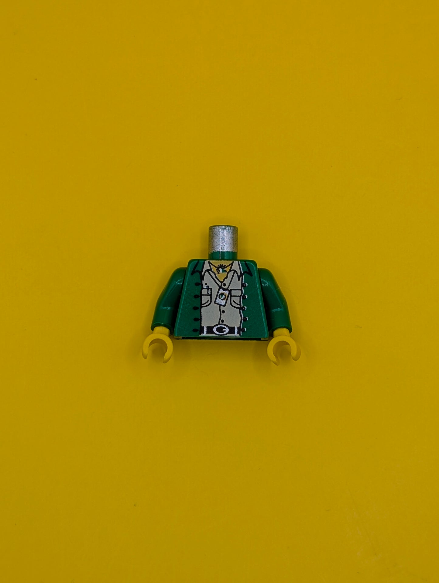 Torso Jacket Open over Tan Shirt with Buttons and Pockets, Black Belt with Silver Buckle, Necklace, Pen, Compass, Yellow Neck Pattern / Green Arms / Yellow Hands 973pa8c01