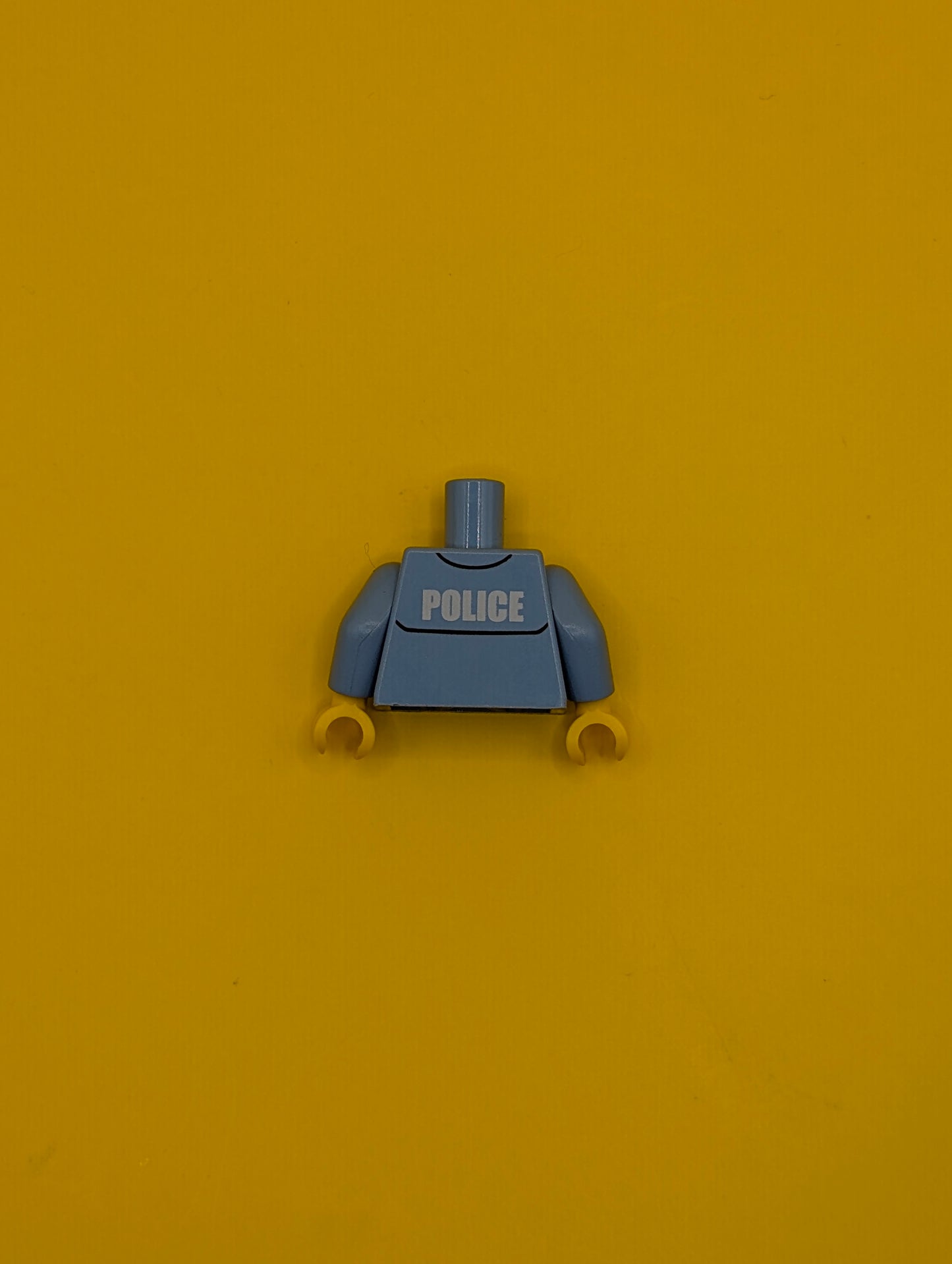 973pb0801c01 Torso Police Uniform Shirt with Pocket and White 'POLICE' on Back, Gold Badge, Dark Blue Tie Pattern / Medium Blue Arms / Yellow Hands Lego Part