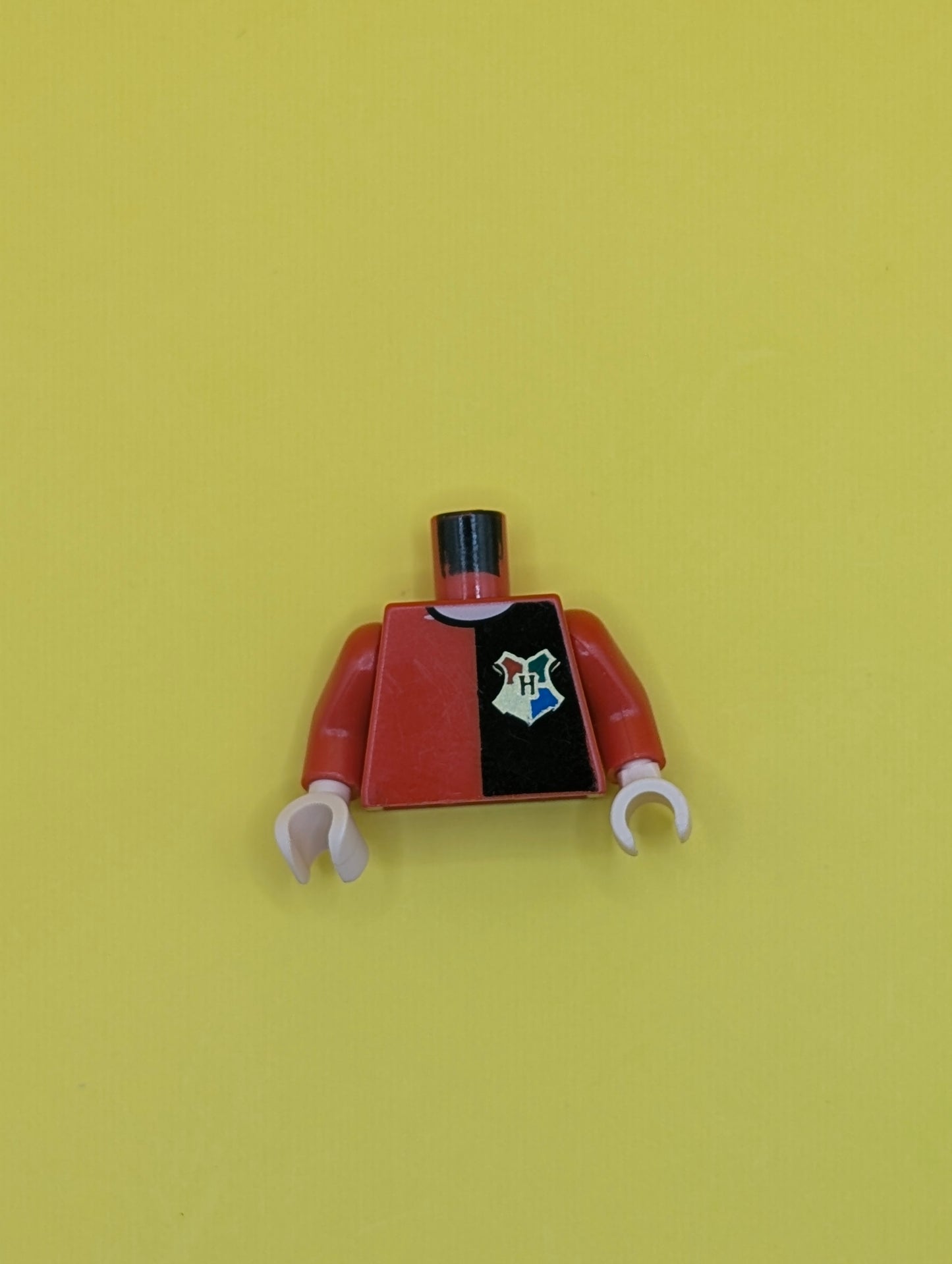 Torso Shirt with Black Left Half, Hogwarts Emblem, and Gold 'POTTER' and Star on Back, Light Nougat Neck Pattern / Red Arm Left / Black Arm Right / Light Nougat Hands 973pb0331c01 Lego