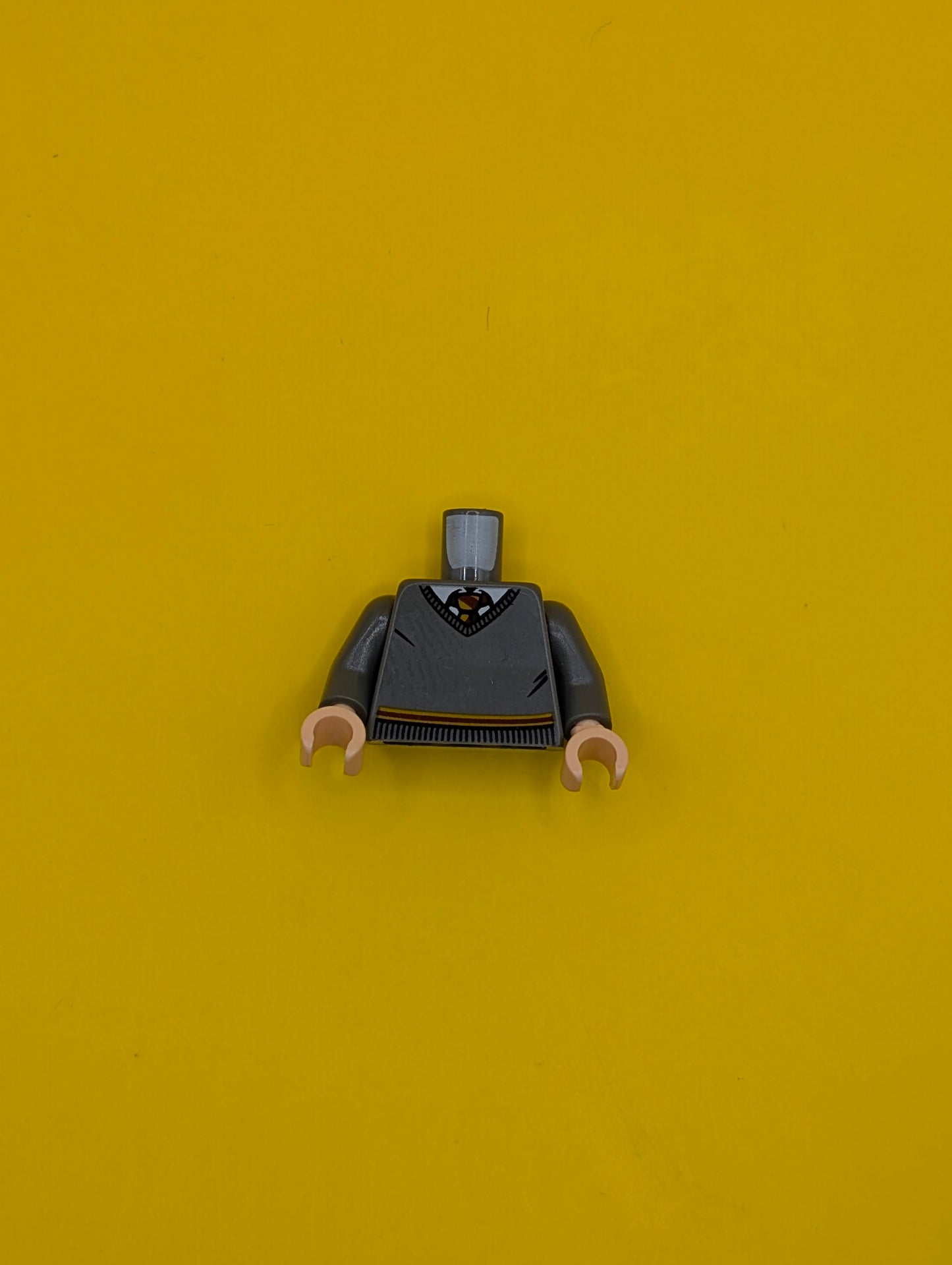 973pb3192c01 Torso V-Neck Sweater, White Collar, Red and Yellow Tie and Waist Trim (Gryffindor) Pattern / Dark Bluish Gray Arms / Light Nougat Hands Lego Part