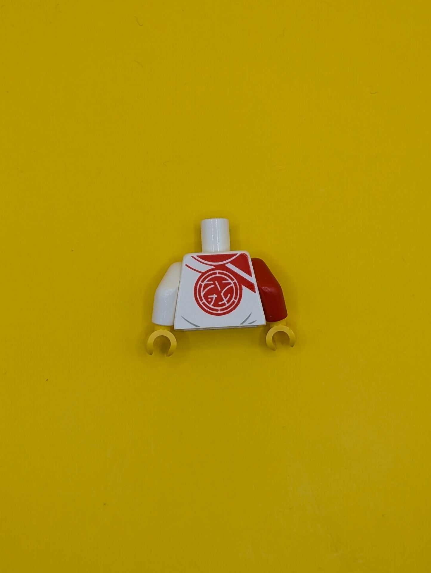 973pb5051c01 Torso Robe with Red Trim, Lines, and Ninjago Logogram 'DOJO' over Tan Shirt, Core Logo on Back Pattern / White Arm Left / Red Arm Right / Yellow Hands Lego Part
